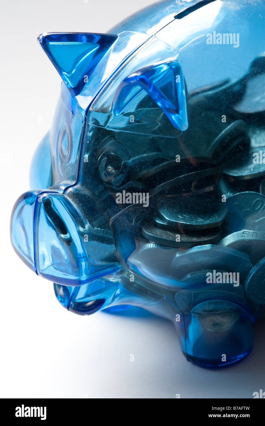Plastica blu salvadanaio con monete risparmi soldi REGNO UNITO Foto Stock