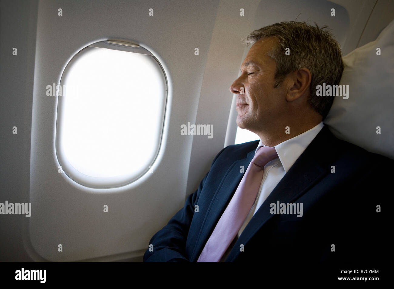 Un imprenditore di dormire su un piano Foto Stock