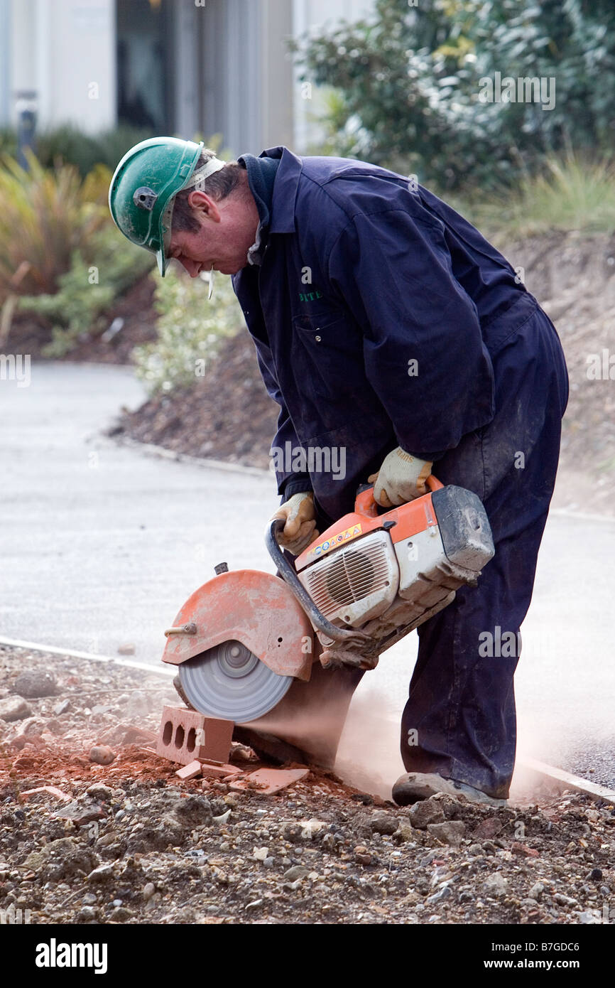 Workman usando una smerigliatrice angolare per tagliare un mattone Foto  stock - Alamy