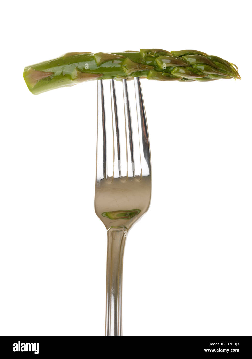 Heathy freschi cotti gara asparagi di lusso le verdure su una forcella isolata contro uno sfondo bianco con nessun popolo e un tracciato di ritaglio Foto Stock