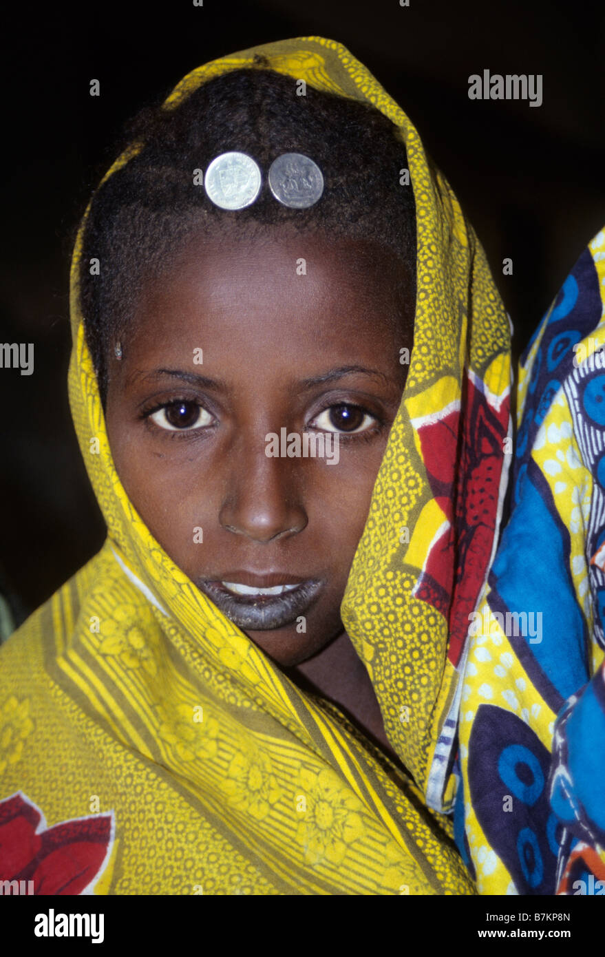 Tonkassare, Niger. Un Fulani Ragazza con due pesewa cinque monete nigeriano nei suoi capelli come gioielli. Foto Stock