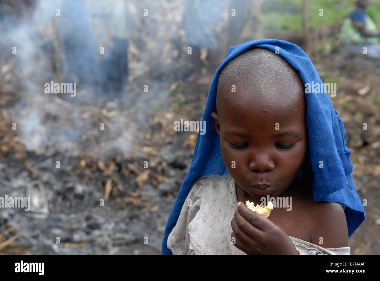 Un ragazzo sfollato mangia Cassava in un campo DP improvvisato Nord Kivu, Repubblica Democratica del Congo Africa Foto Stock