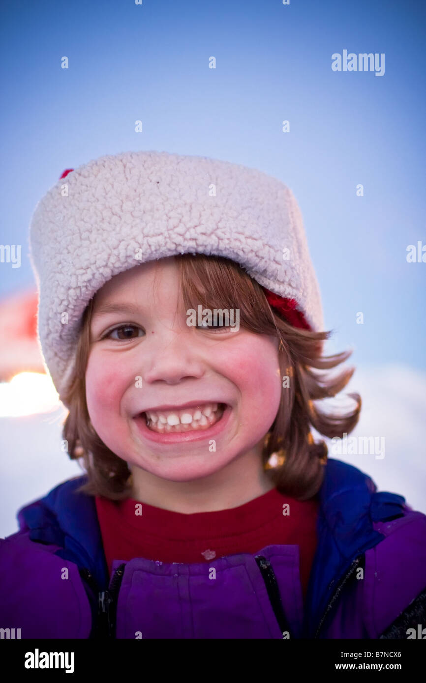 Ritratto di giovane ragazzo con le guance rosate, indossando un cappello invernale Foto Stock