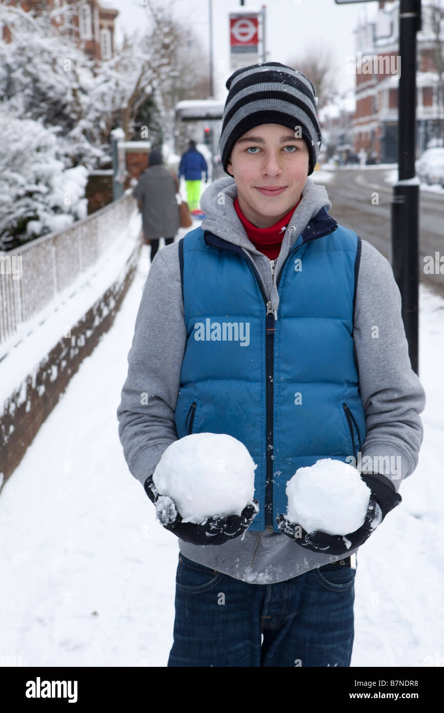 Un ragazzo adolescente con due grandi snowballs nel nord di Londra Febbraio 2009 dopo il più pesante la caduta di neve a Londra per 18 anni Foto Stock