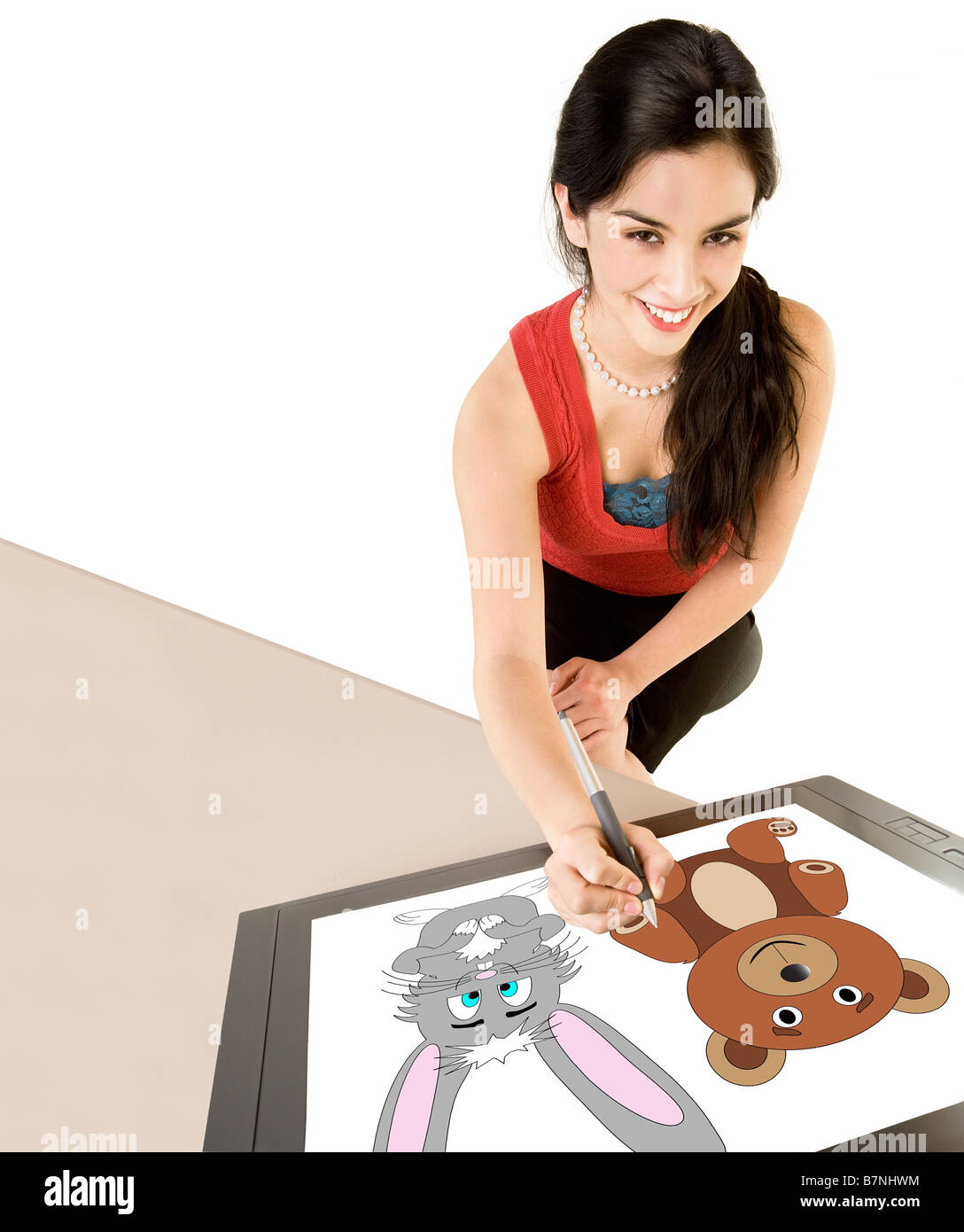 Una giovane donna è il disegno su una tavoletta digitale Foto Stock