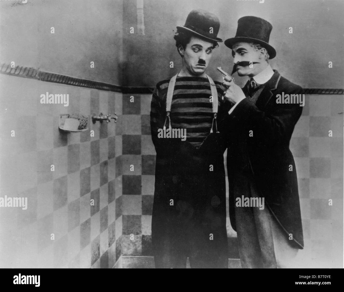 Il campione Anno: 1915 Direttore USA Charlie Chaplin Charlie Chaplin , leone bianco Foto Stock