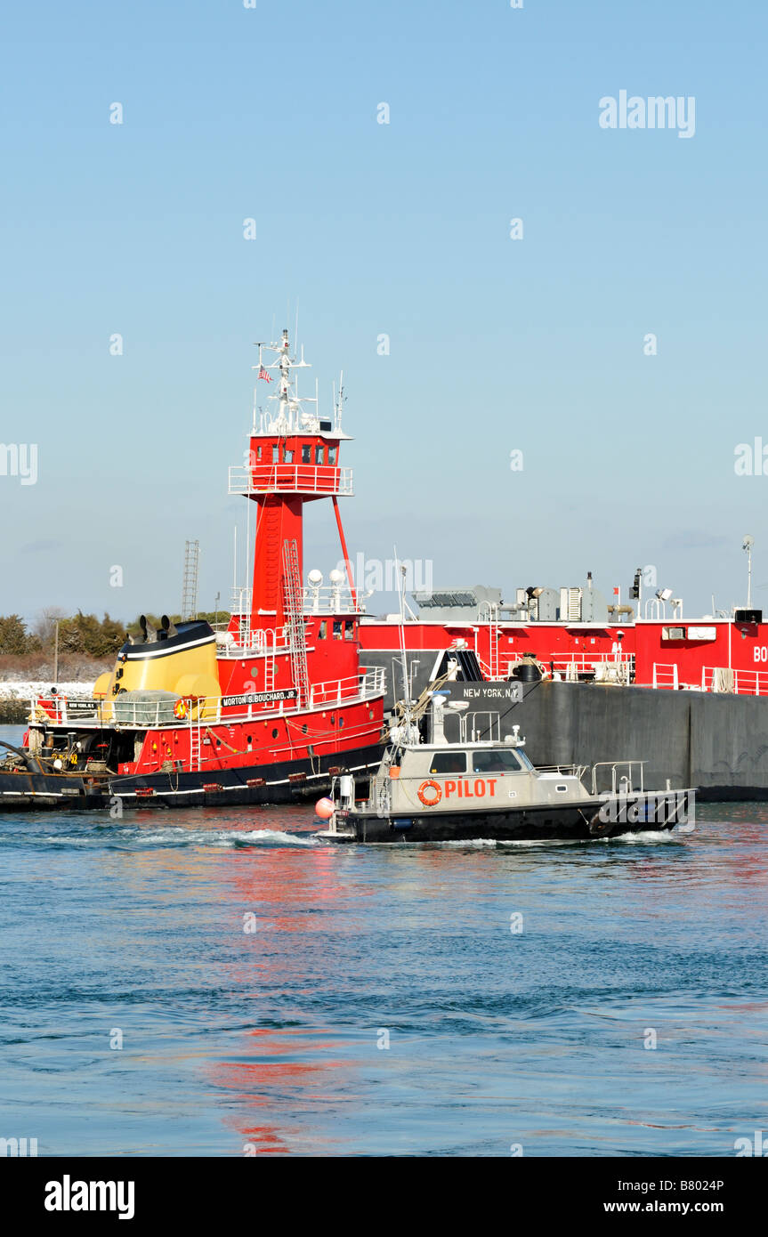 Red rimorchiatore a traino e chiatte da 'Bouchard trasporto' azienda con [barca pilota] accanto Foto Stock