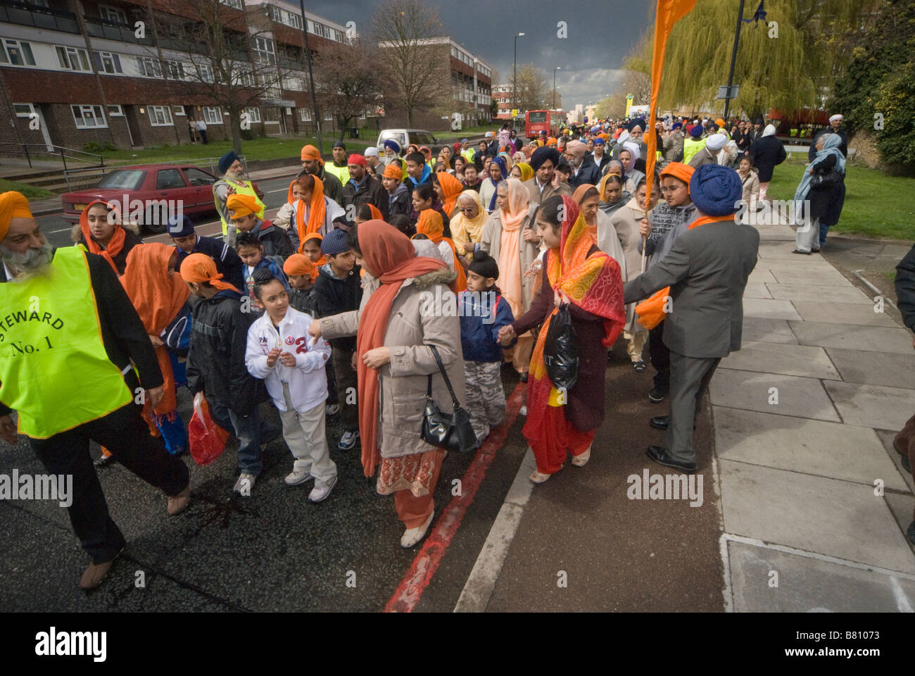 La folla di Sikh segue dietro il Guru Granth Sahib nel Vaisakhi processione attraverso Woolwich, Londra, Aprile 2008 Foto Stock