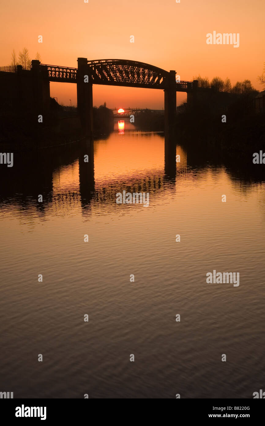 Manchester Ship Canal al tramonto con Latchford Railway Viaduct in primo piano, Warrington, Cheshire, Inghilterra, Regno Unito, Europa Foto Stock