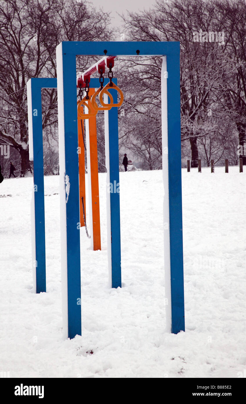 Coperta di neve attrezzatura ginnica in campi collinosi Park, Lewisham Foto Stock