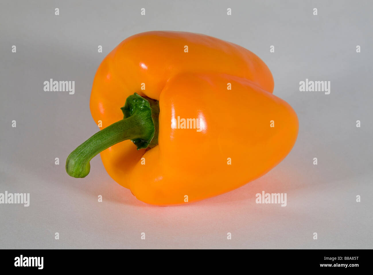Un colore giallo o arancio il peperone tagliato a fette o intero. Foto Stock