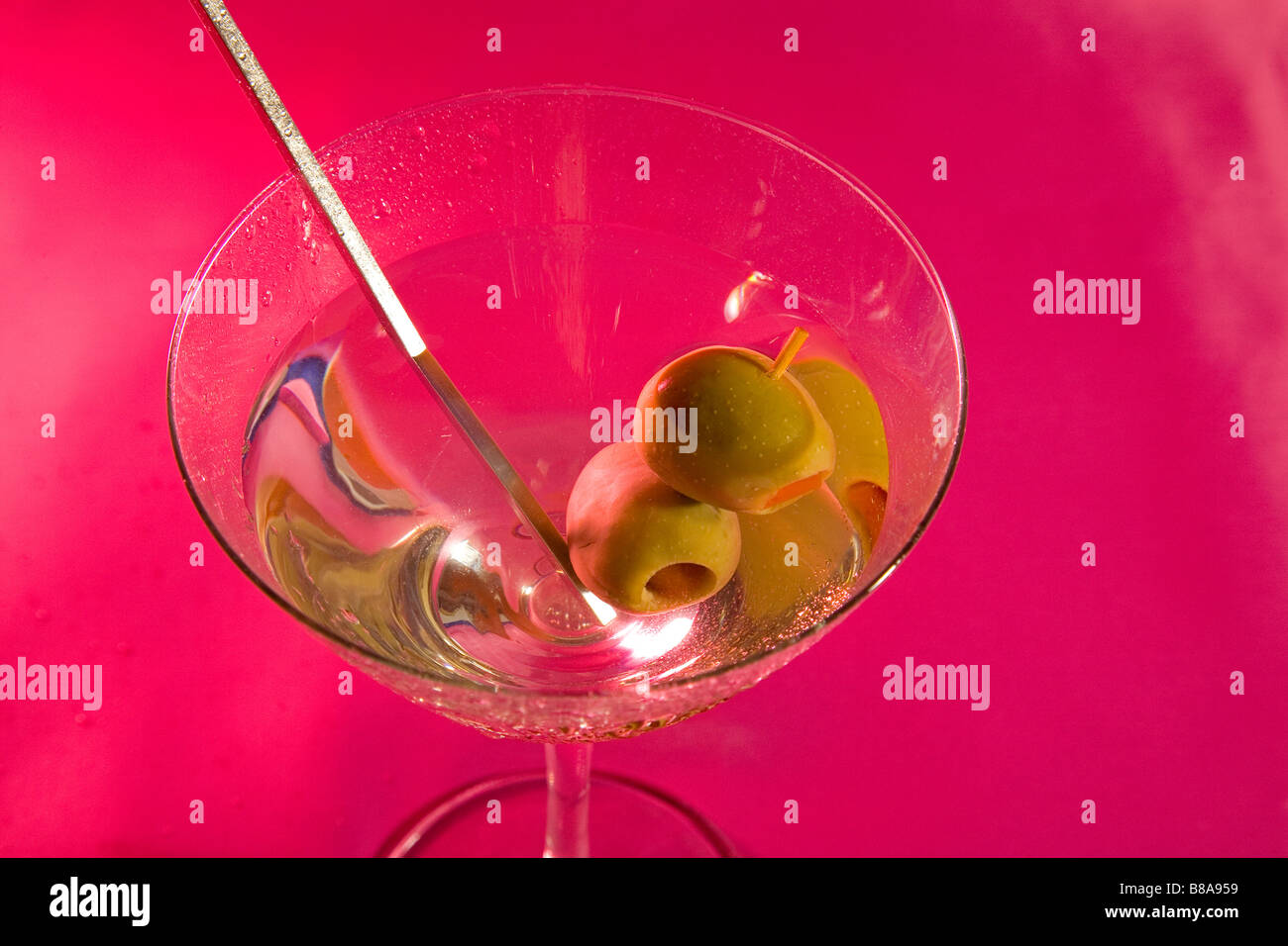 Due spagnolo Olive e un swizzle stick in un Vodka Martini agitato non mescolato Foto Stock