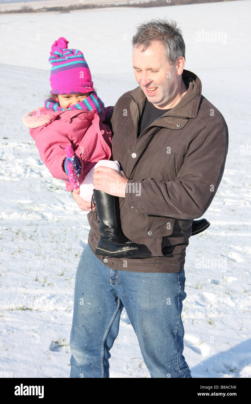 Figlia di padre bianco figlia toddlerl etnica nero razza mista sorridenti divertirsi giocando a snow ice giovani Foto Stock