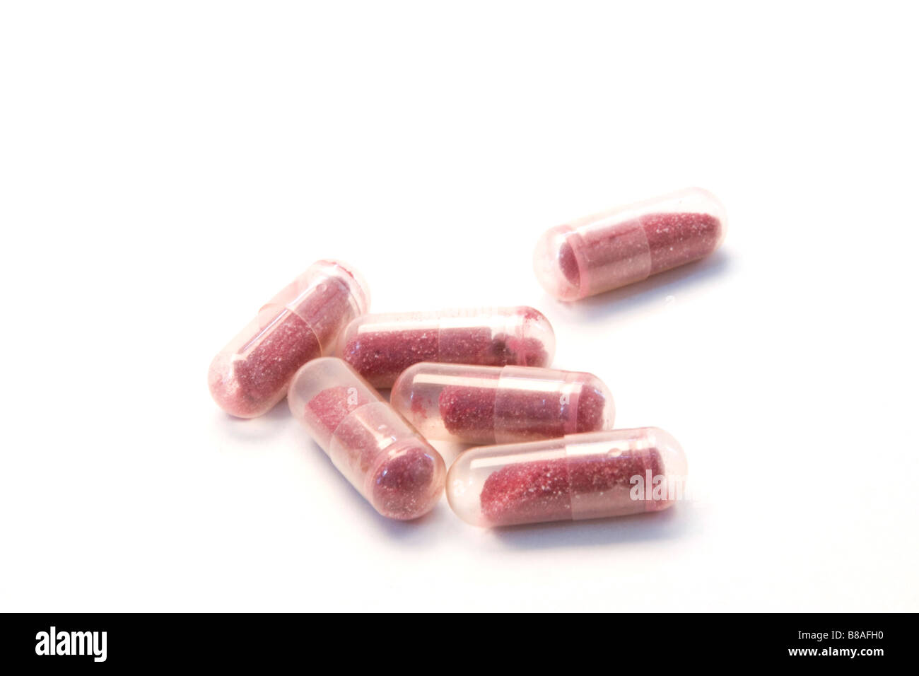 Pillole di mirtillo palustre sono visti in un ritaglio immagine. Foto Stock