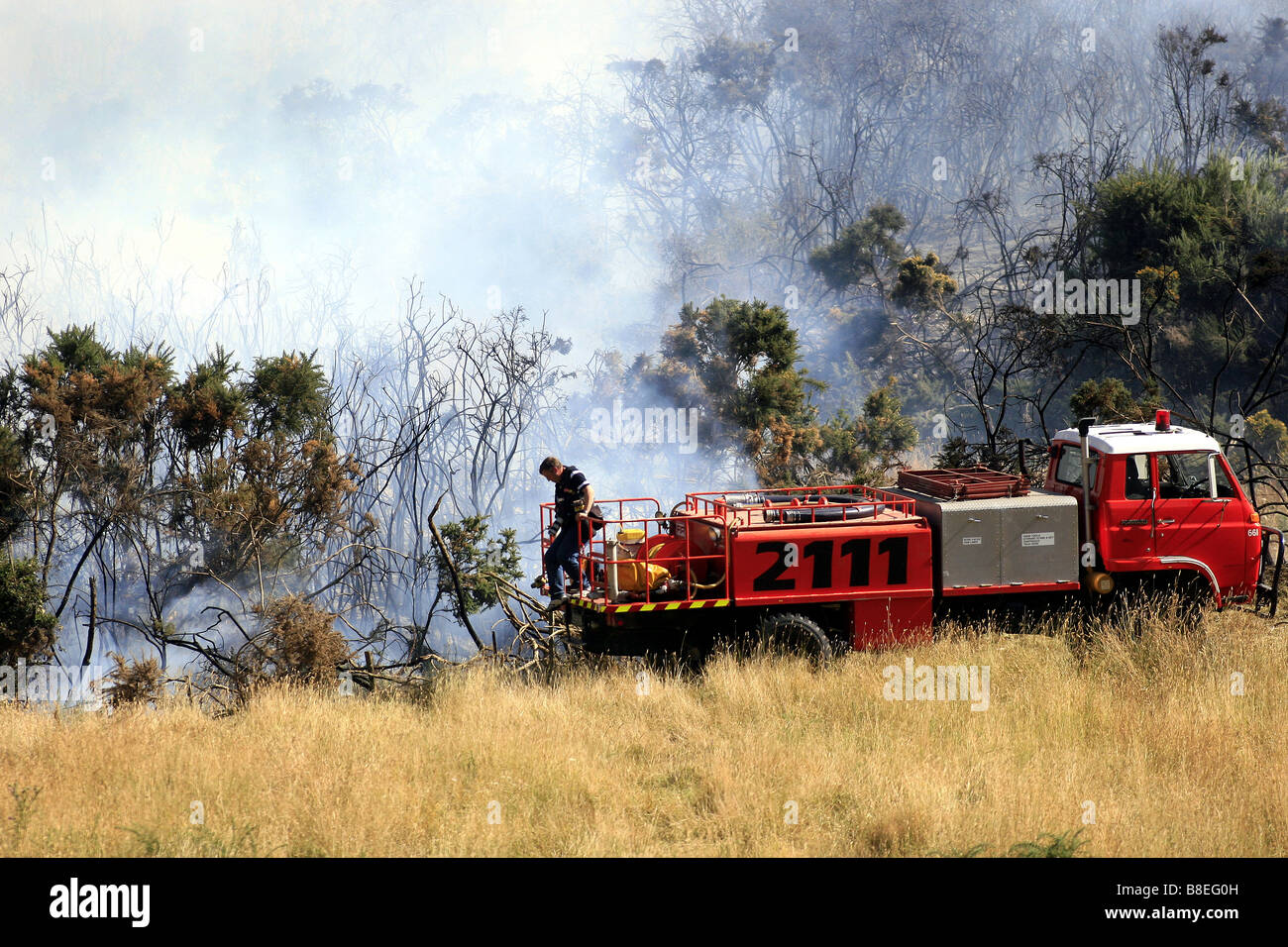 Un vigile del fuoco rurale con camion dei pompieri a bushfire in Nuova Zelanda Foto Stock