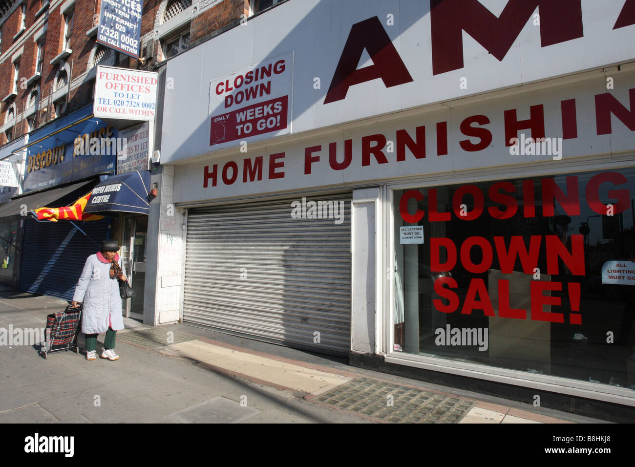 Negozi di vuoto, ha recentemente chiuso nel duro clima economico. Kilburn High Road, Londra. Foto Stock