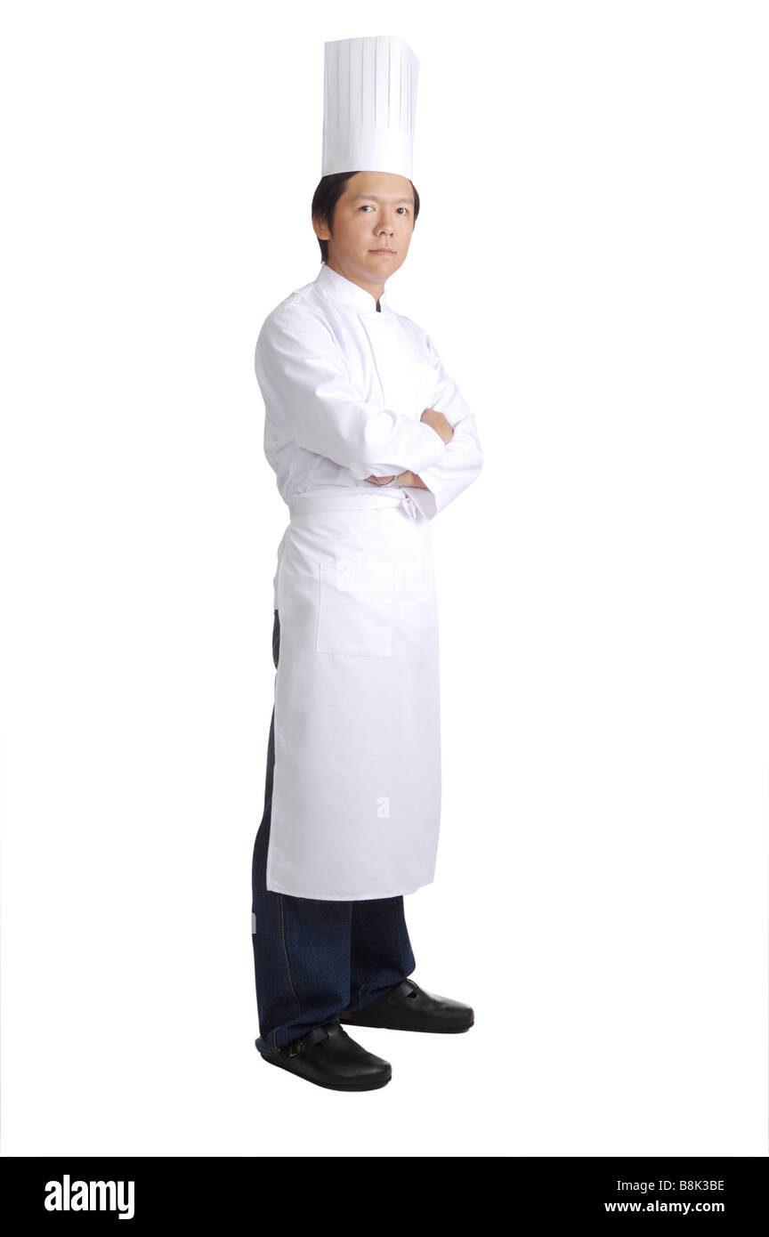 Uomo che indossa lo chef s bianchi e guardando la telecamera Foto Stock