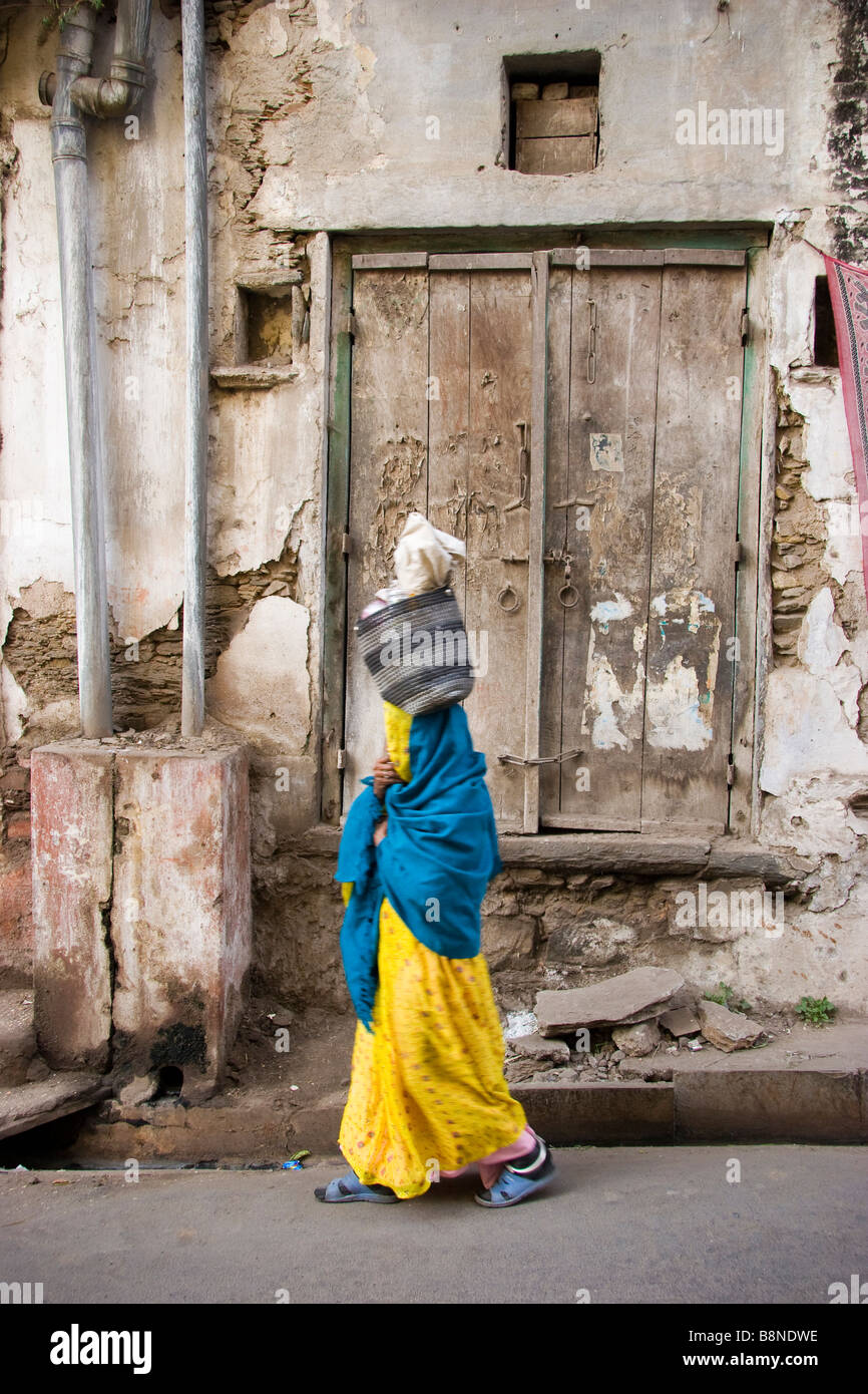 Locale indiana donna cammina giù street Udaipur Rajasthan in India Foto Stock
