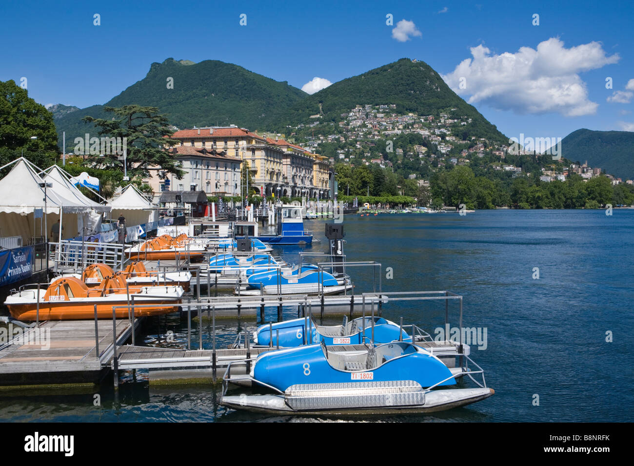 Il porto sul lago di Lugano - Svizzera su una luminosa estate s giorno con  una vasta gamma di barche a remi per affitto Foto stock - Alamy