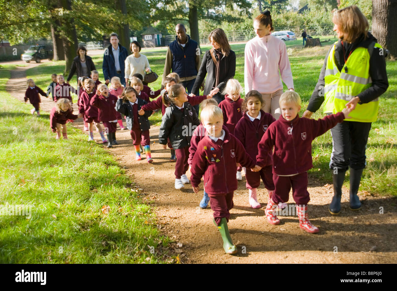 Scuola Junior bambini su supervisionato a piedi con gli insegnanti Foto Stock