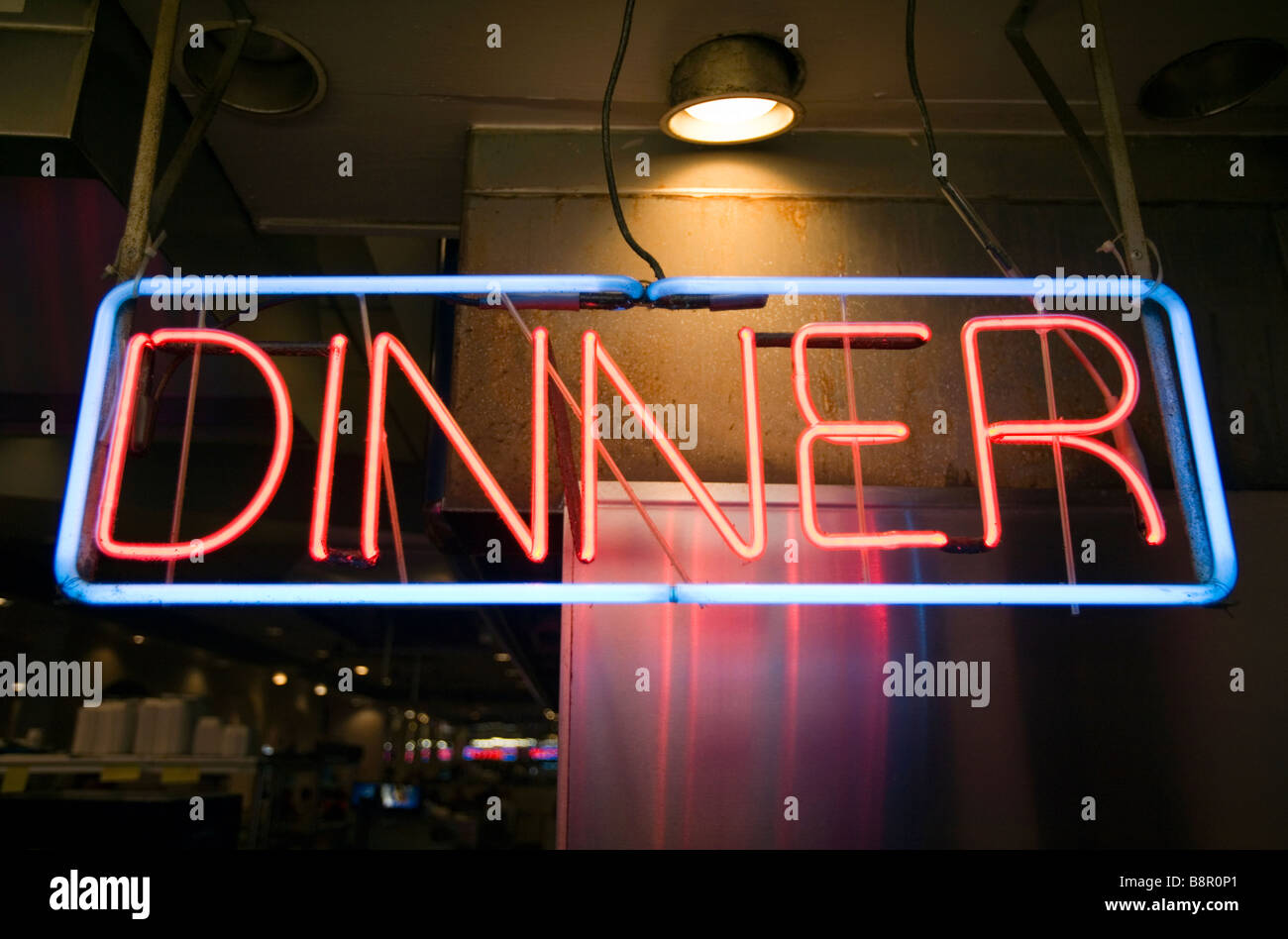 Una cena insegna al neon è illuminata in un ristorante. Foto Stock