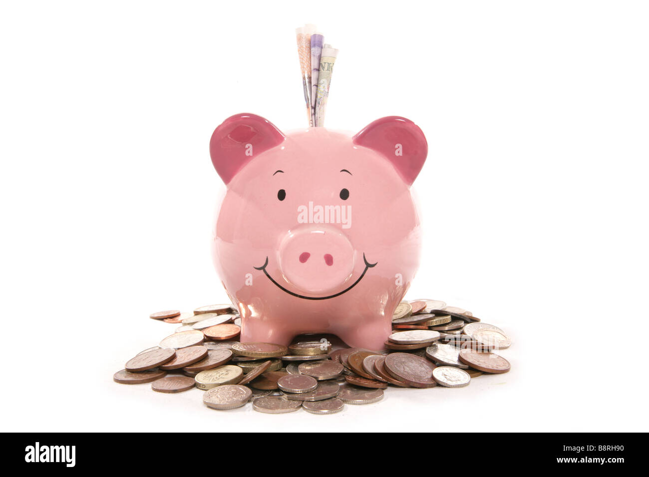 Pila di moneta inglese e denaro casella in studio Foto Stock