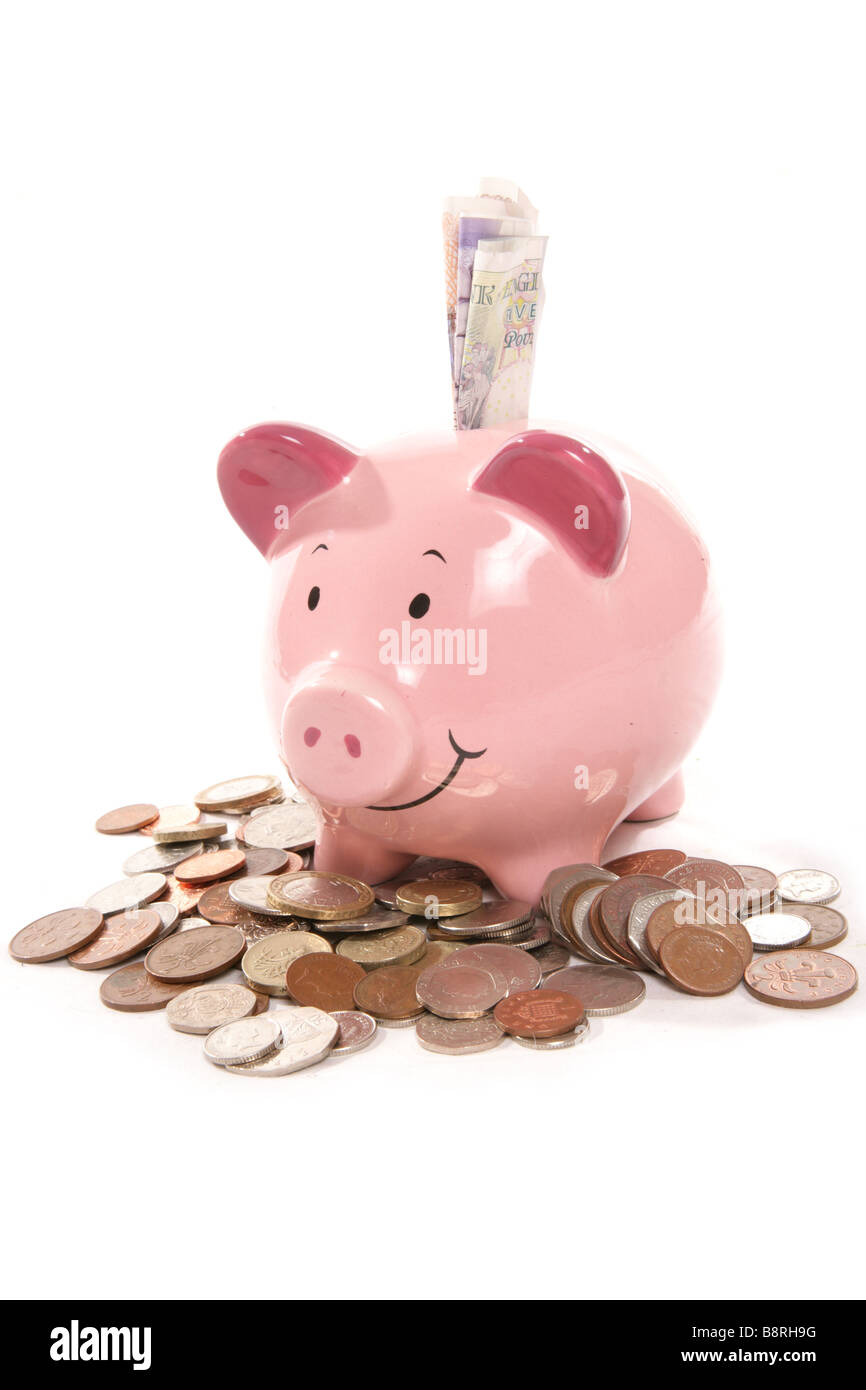 Pila di moneta inglese e denaro casella in studio Foto Stock