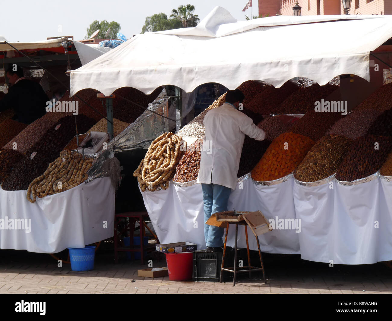 Un bottegaio guarda dopo la sua mercanzia in Djma el Flna, la piazza principale di Marrakech. Foto Stock