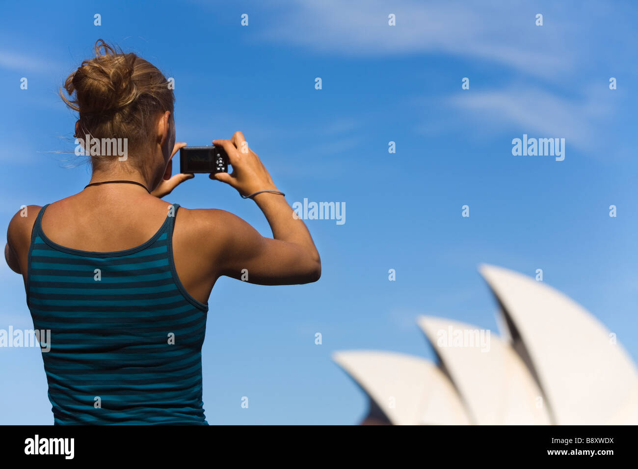 Una donna fotografa la Opera House di Sydney. Sydney, Nuovo Galles del Sud, Australia Foto Stock