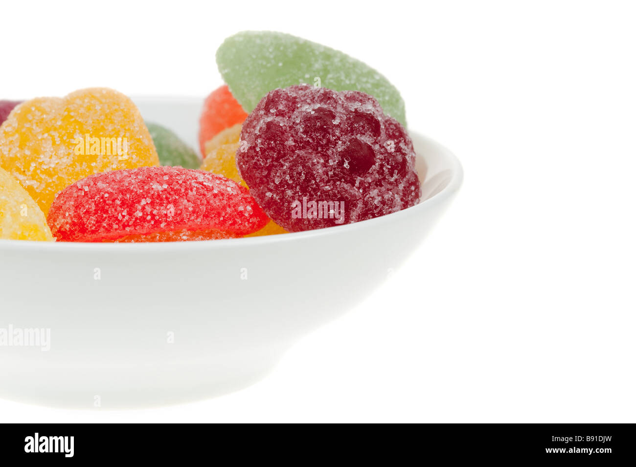 Ciotola di caramella di frutta in molti colori isolati su sfondo bianco Foto Stock