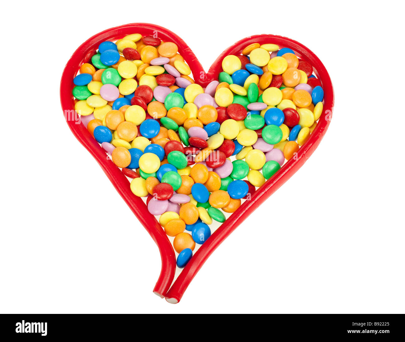Caramelle colorate a forma di cuore isolato su bianco Foto Stock