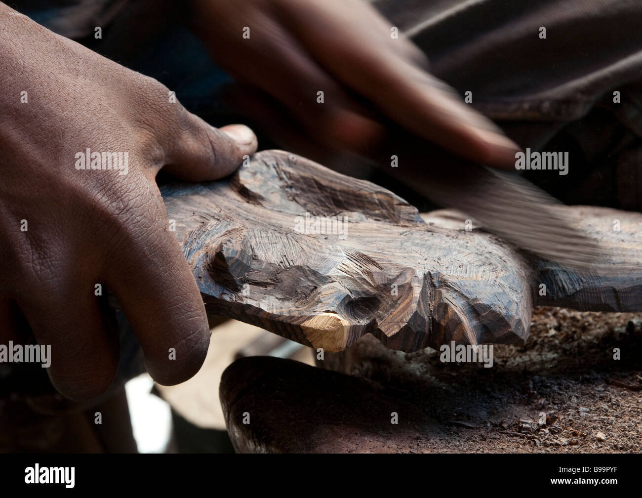 Africa occidentale Mali Bamako mercato artigianale close up di mani lavorando sulla scultura in legno Foto Stock