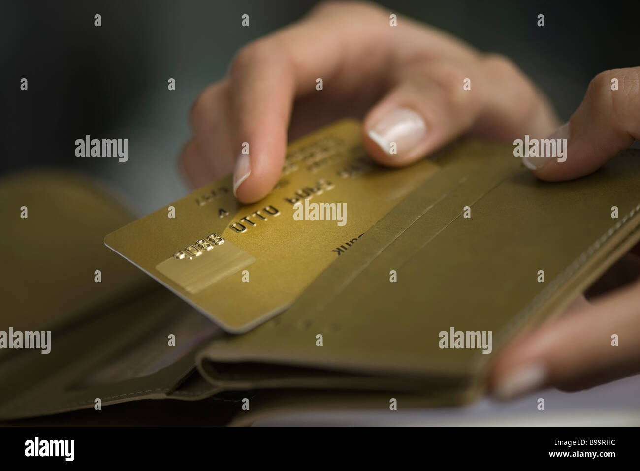Donna prendendo mano carta di credito al di fuori del portafoglio Foto Stock