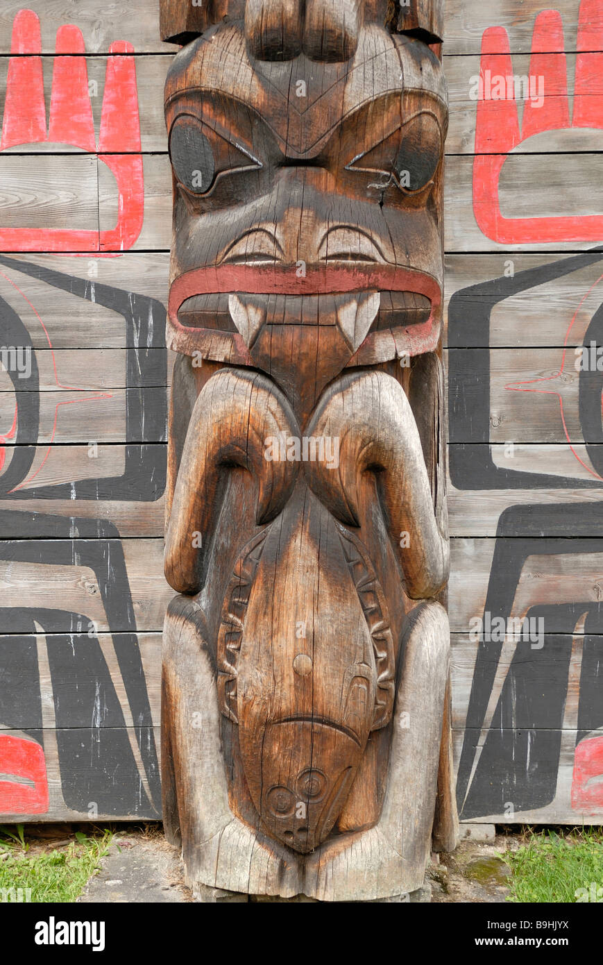 Il totem pole al di fuori di un nativo americano long house, dettaglio K'sun villaggio storico museo, Hazelton, British Columbia, Canada, N Foto Stock