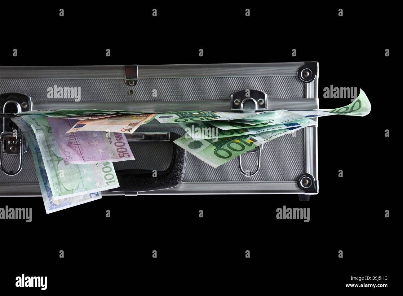 Banconote fuori di una valigia di metallo Foto Stock