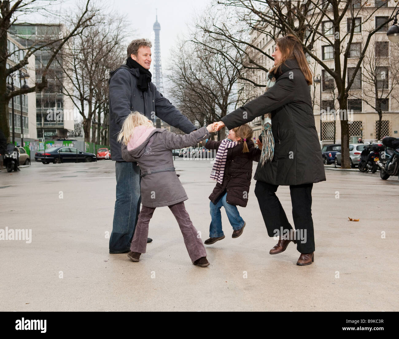 Famiglia dancing vicino a Torre Eiffel Foto Stock