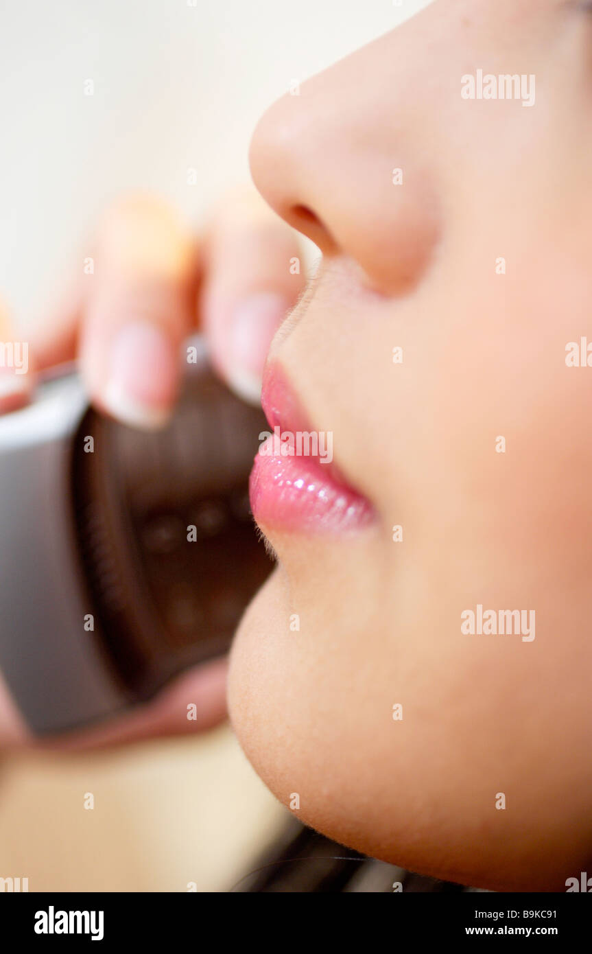 Close-up di labbra ed il naso della donna con mobile Foto Stock