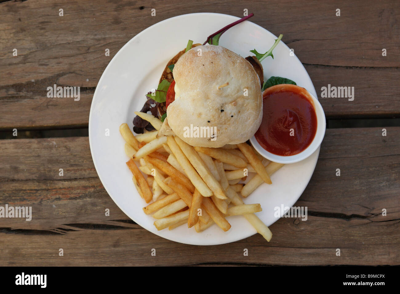 Hamburger e patatine su un tavolo rustico Foto Stock