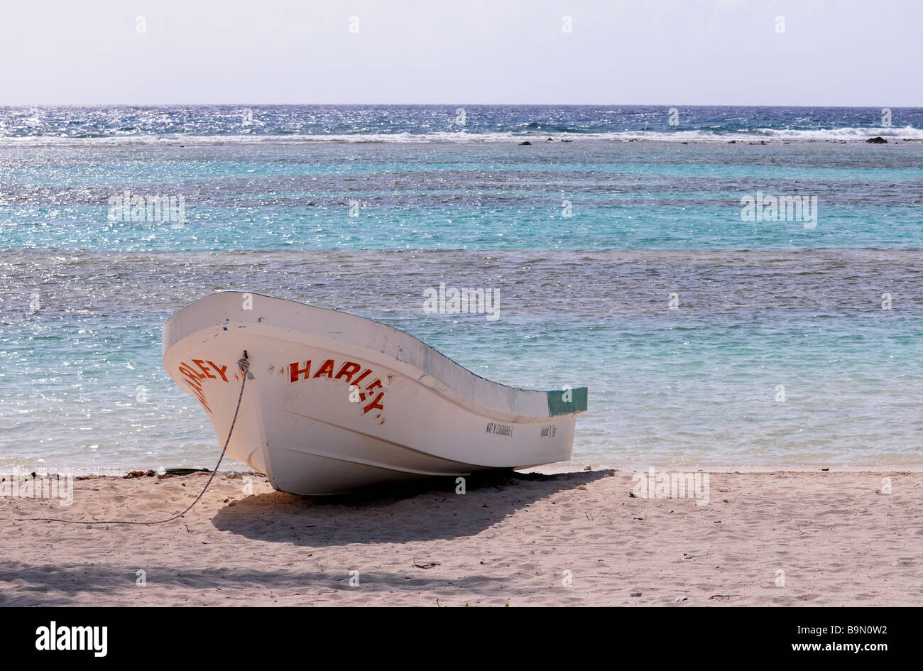 Una barca spiaggiata sulla sabbia fuori il mare smeraldo, costa, spiaggia di Messico, Sud America Belize, dei Caraibi. Pura vacanza. Foto Stock