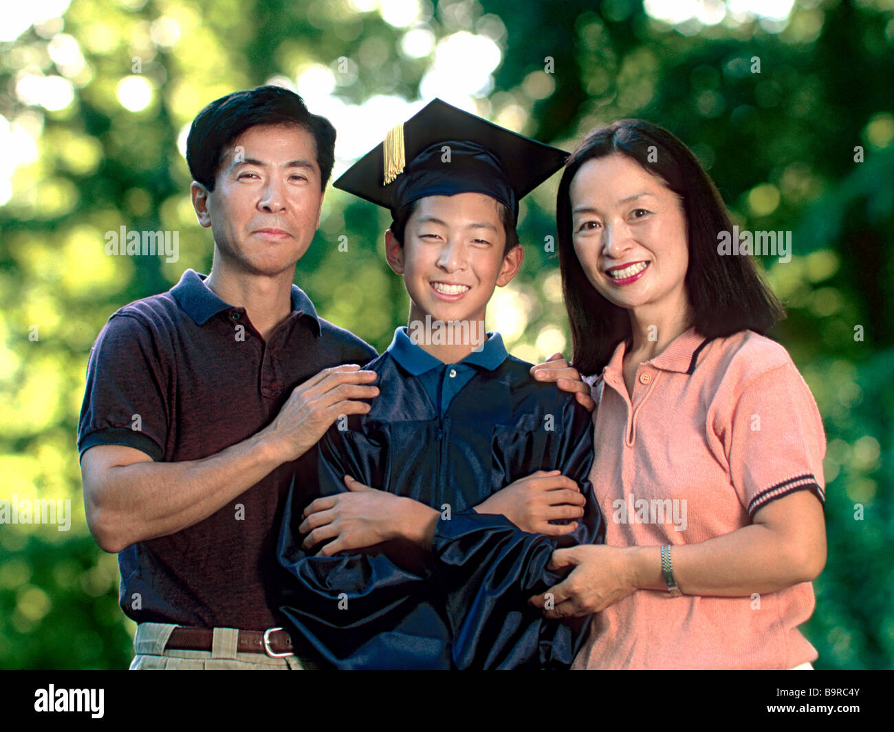 Japanese-American genitori con figlio che ha appena laureato dalla scuola. Foto Stock