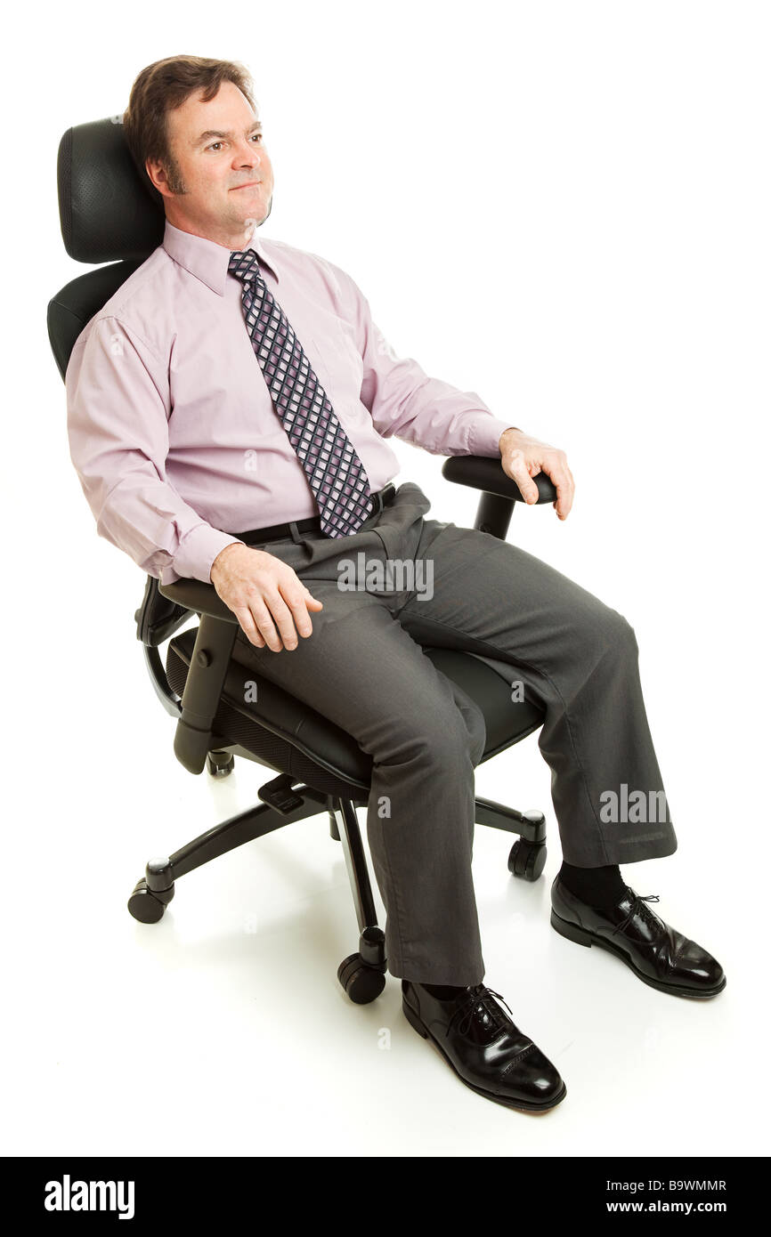 Imprenditore in seduta ergonomica sedia executive isolati su whit Foto Stock