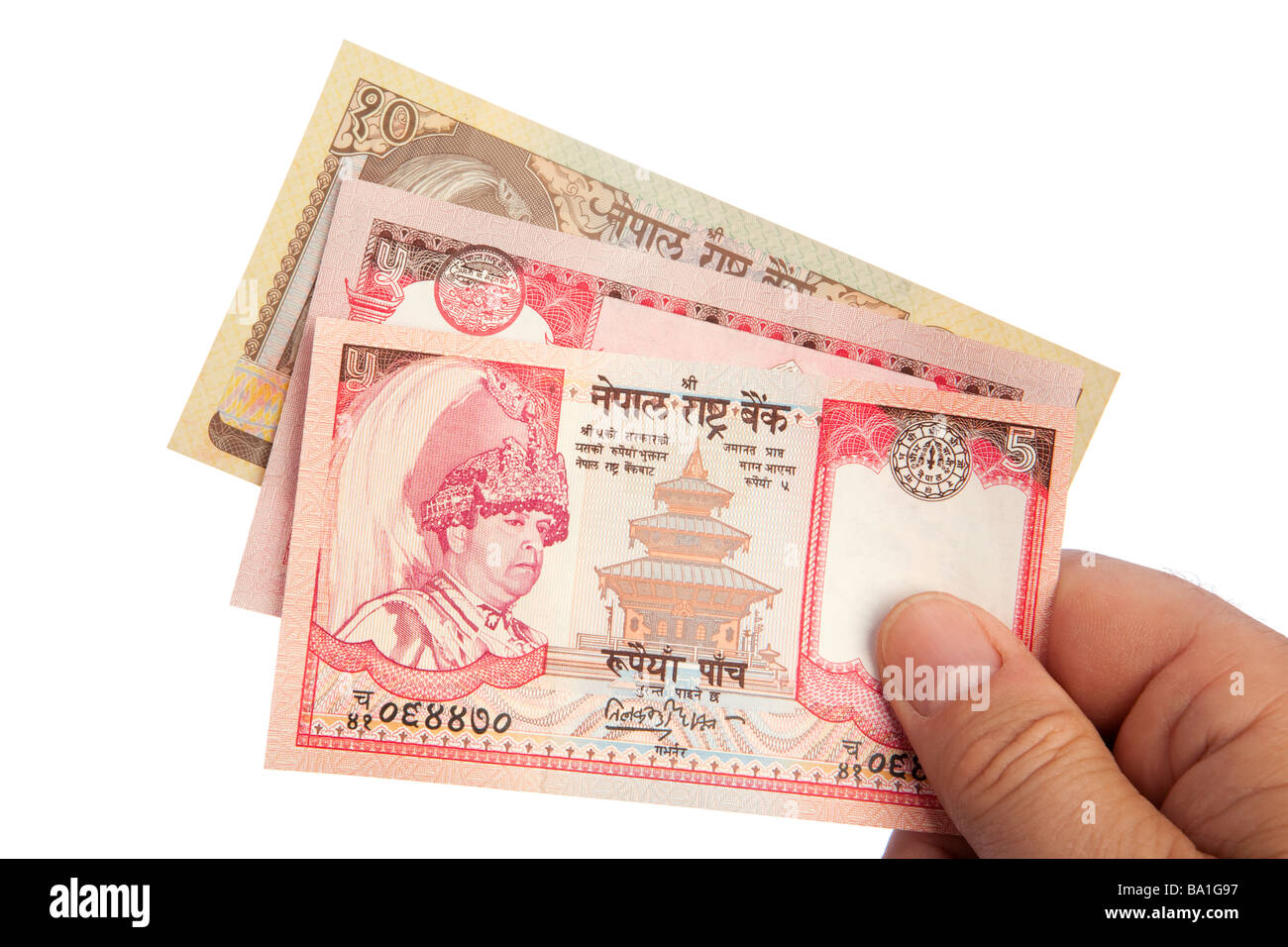 Maschio di denaro mano azienda manciata di Re Gyendra valuta nepalese Foto Stock