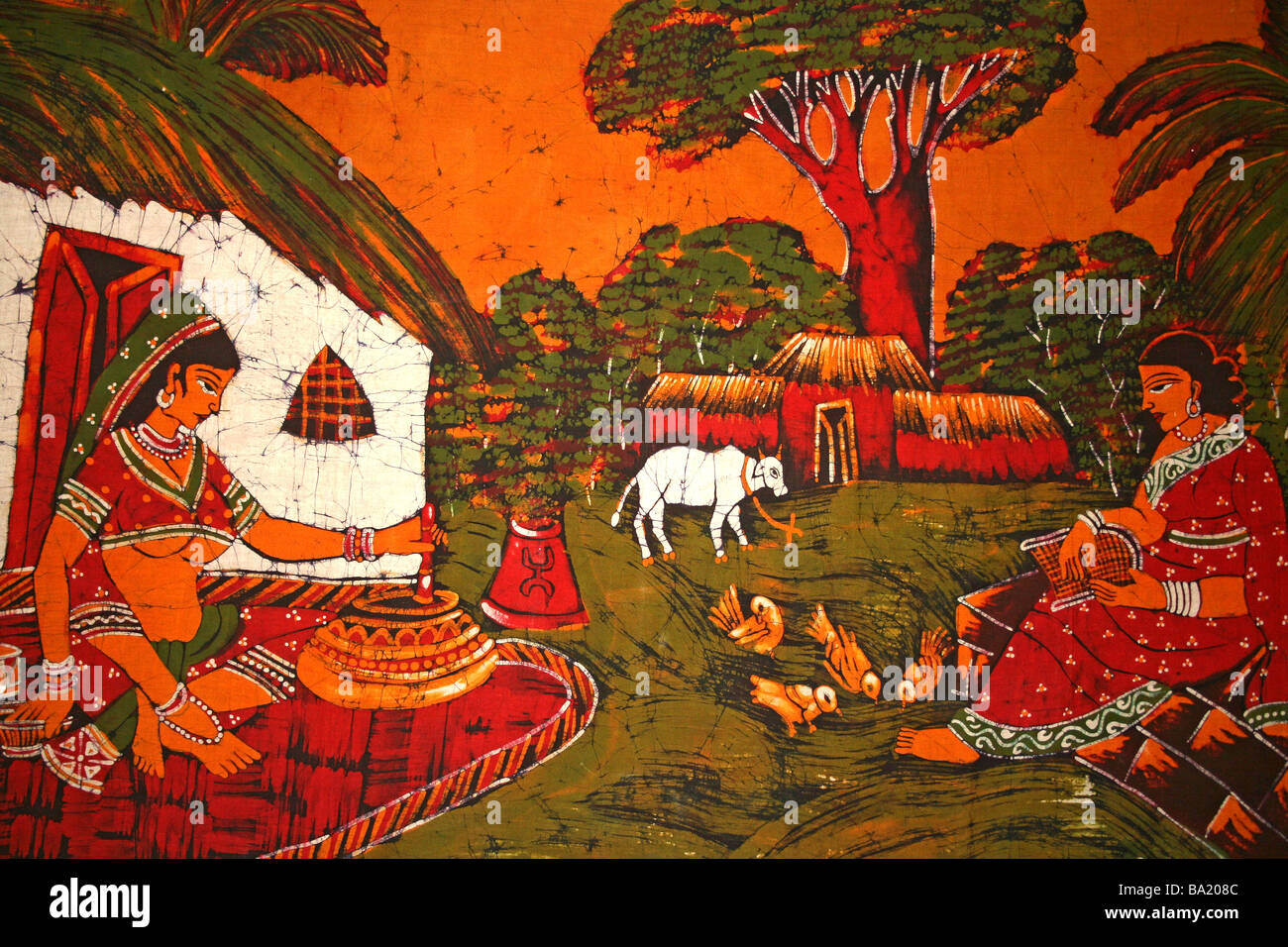 Il batik che mostra il Villaggio Tradizionale scena con donne indiane e rifugi Foto Stock