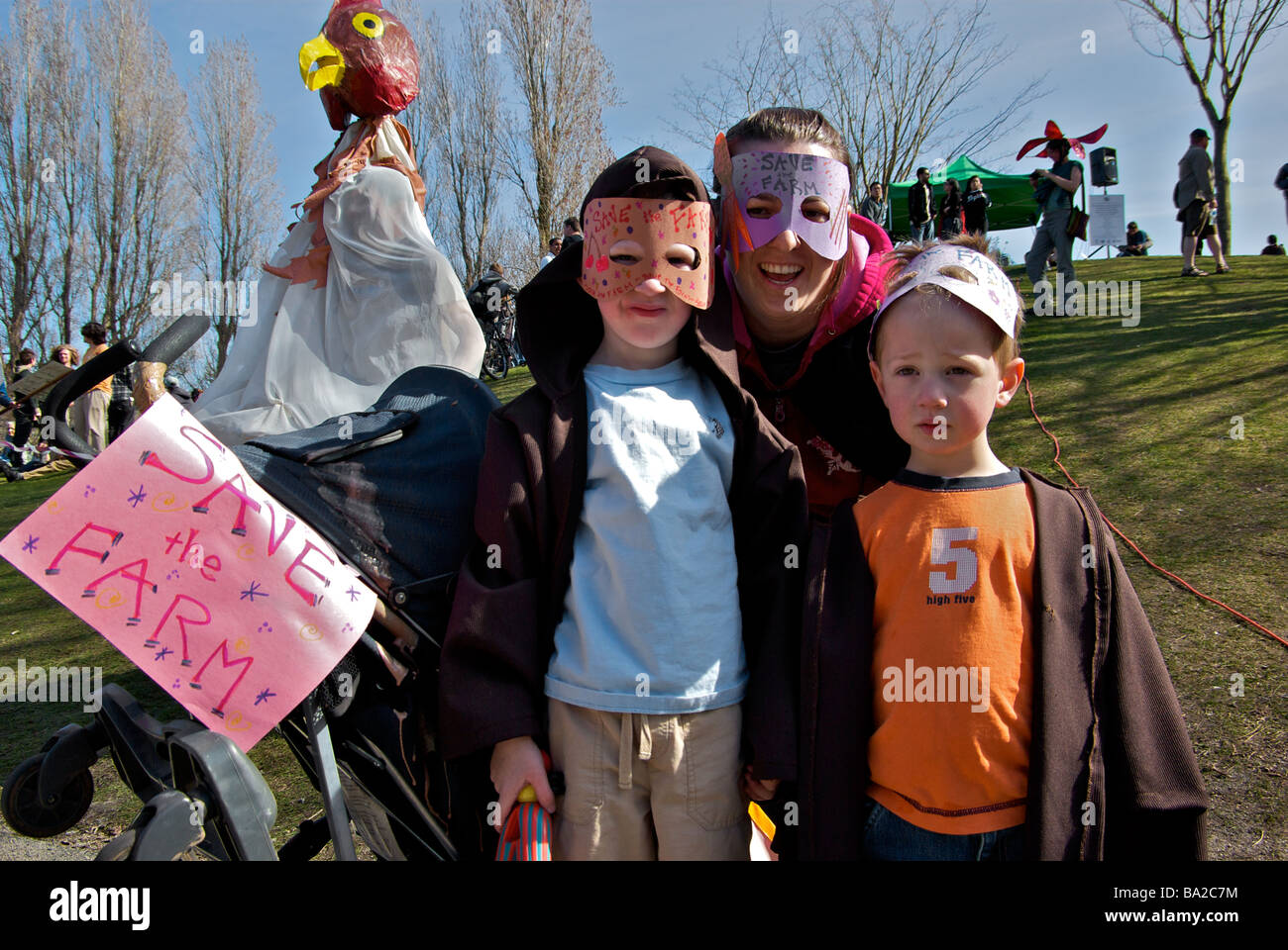 I manifestanti che indossano maschere che frequentano la salva la fattoria marcia di protesta in British Columbia University campus Foto Stock