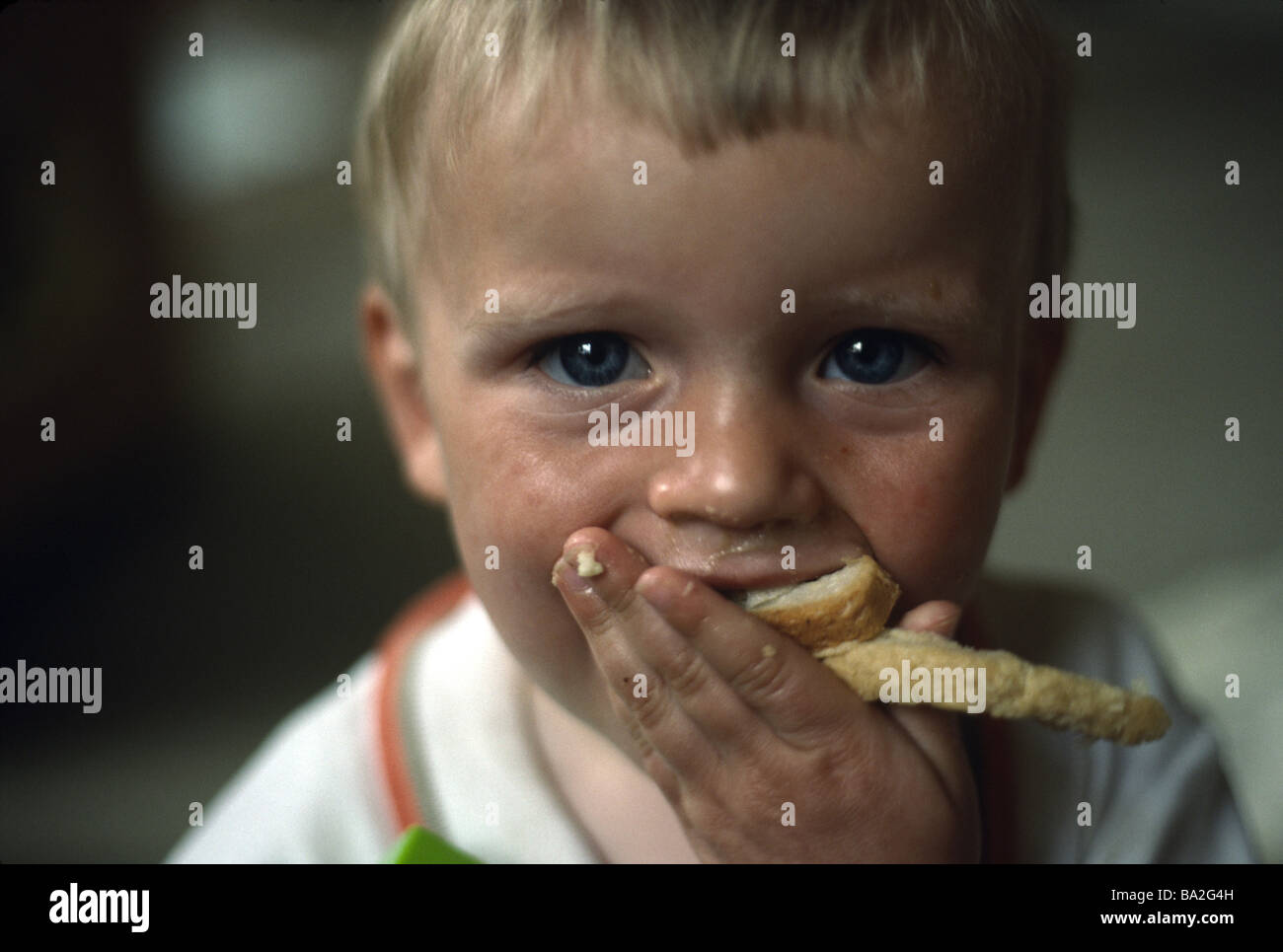 Ragazzo giovane mangiare un panino Foto Stock