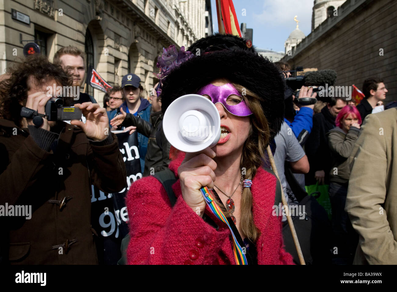 Una femmina protester parla attraverso un bullhorn durante un mese di marzo presso la banca di Inghilterra durante la G20 protesta Foto Stock