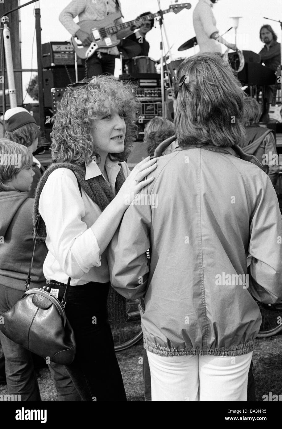 Negli anni settanta, foto in bianco e nero, persone, due giovani ragazze a parlare durante un concerto pop, camicetta, giacca, pantaloni, di età compresa tra i 18 e i 22 anni Foto Stock