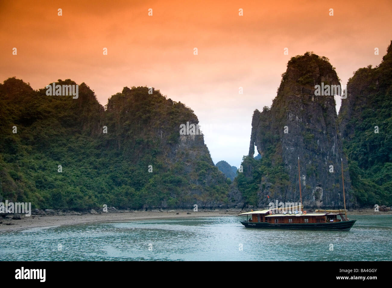 Vedute panoramiche di pietre calcaree carsiche e le imbarcazioni turistiche nella Baia di Ha Long Vietnam Foto Stock