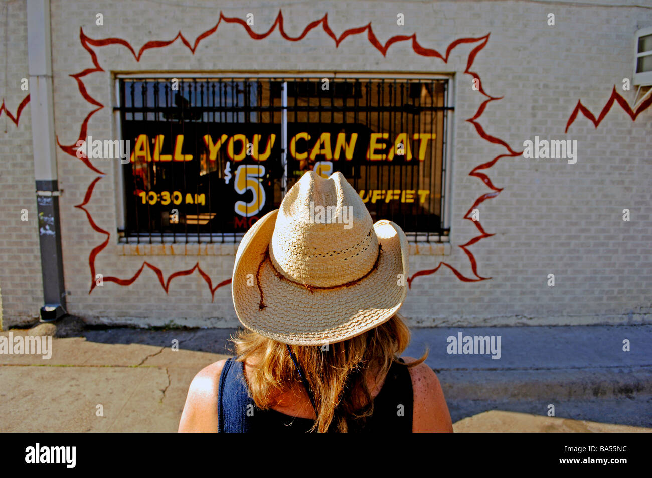 Donna con western cappello da cowboy al di fuori di un messicano 'tutto quello che potete mangiare' Ristorante Foto Stock