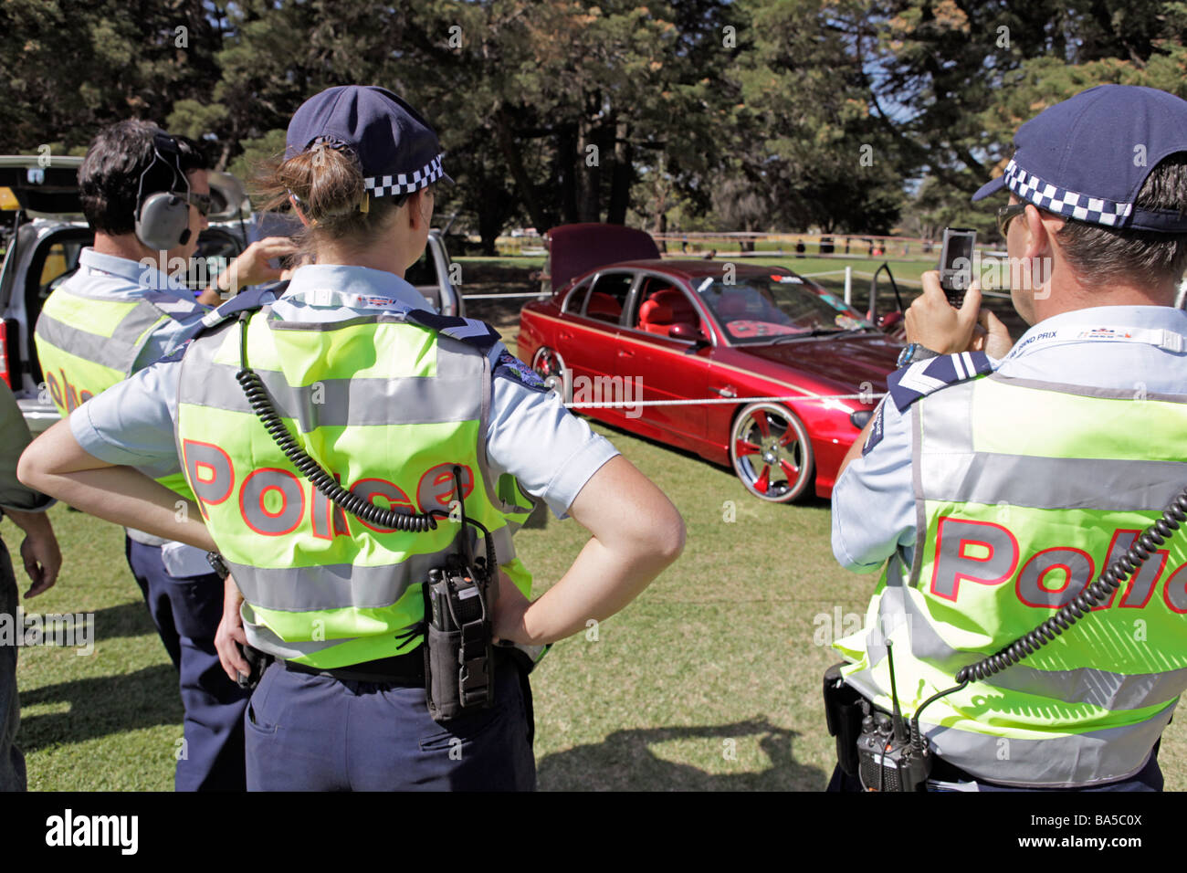 Gli ufficiali di polizia ammirando sportivo Holden automobili al 2009 Australian Grand Prix, Albert Park di Melbourne. Foto Stock